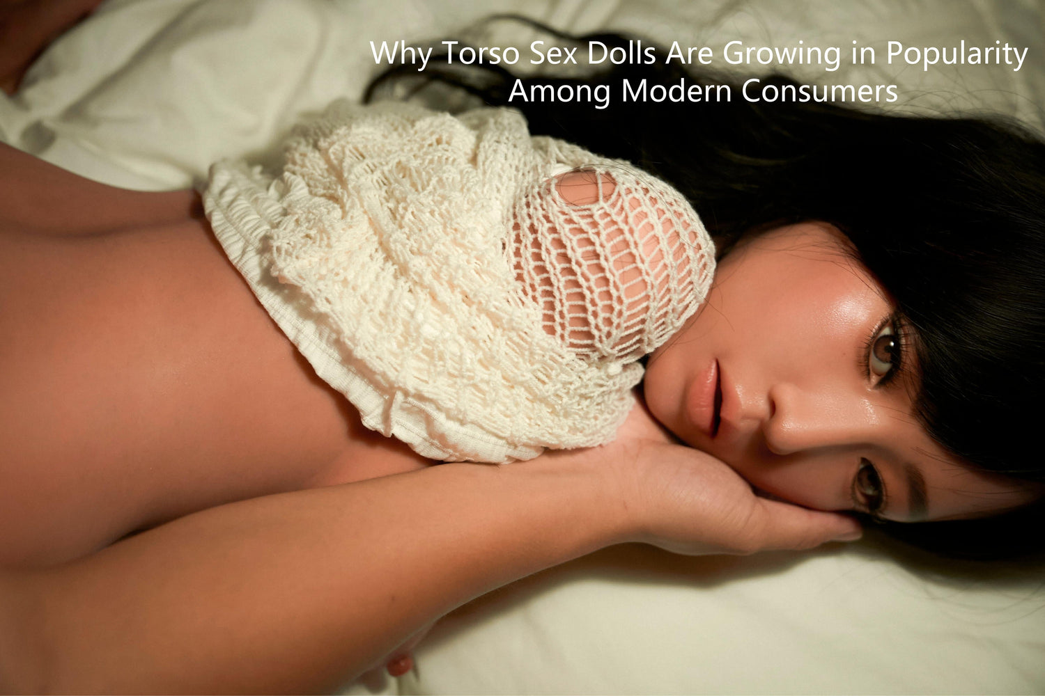 A torso doll lying on a bed.